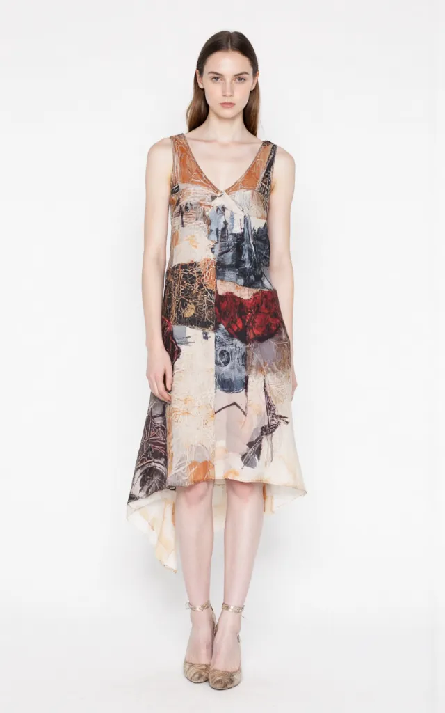 A French female model wearing Artistic   style clothing, against a white background, in a front   facing shot focusing on shoes